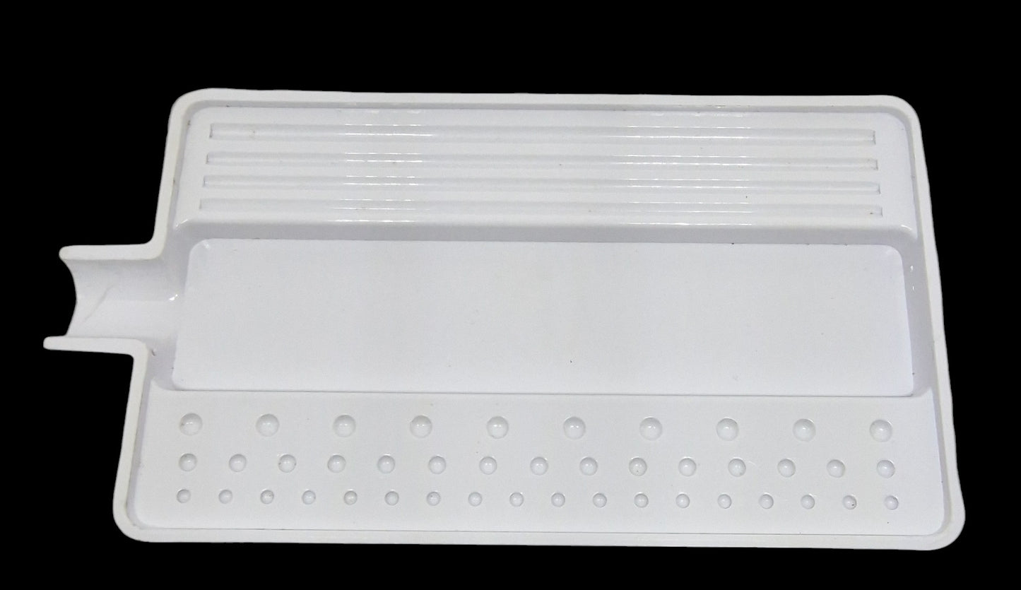 A white plastic sorting tray with various-sized grooves on one side for size sorting, and specific indentations on the other side. It includes a pour spout on the side.