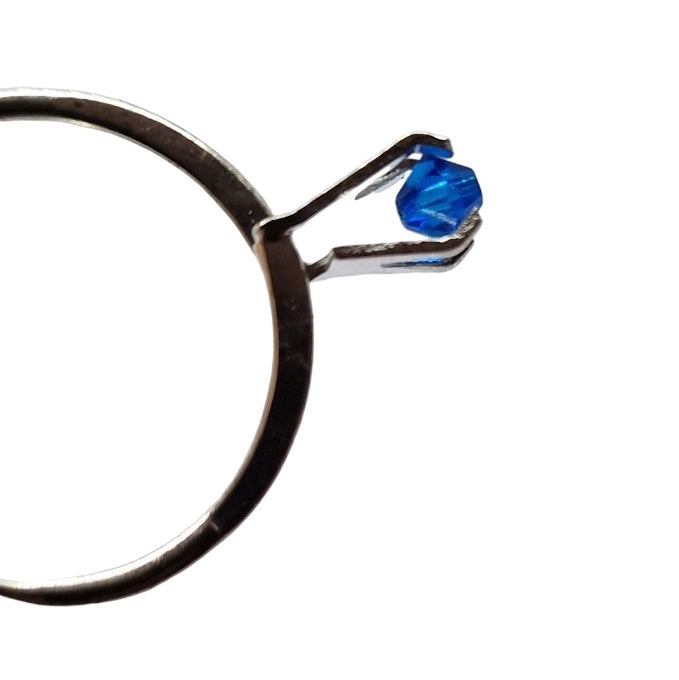 Close up of a blue stone in a ring setting