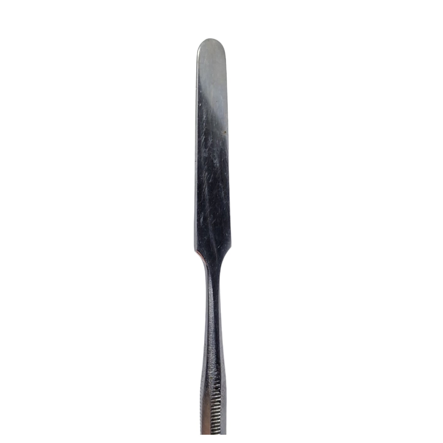A single stainless steel wax carving tool with a straight blade and ribbed handle.