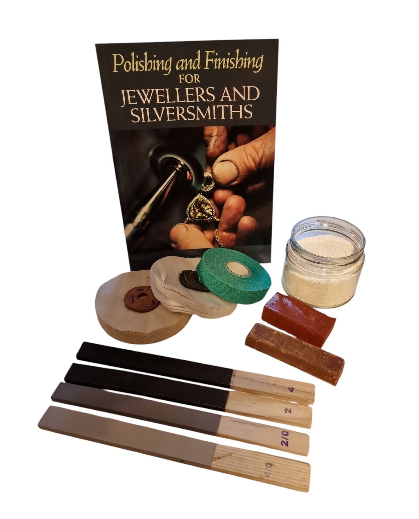 A collection of polishing and finishing tools for jewellers and silversmiths, including a book, finger tape, a calico mop, a reflex mop, various powder compounds, and emery buffing sticks.