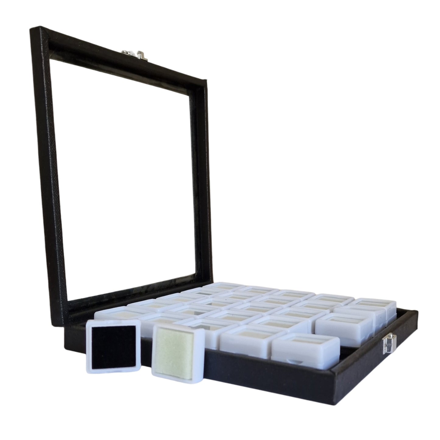 Black display case with glass front containing small white boxes on a white background