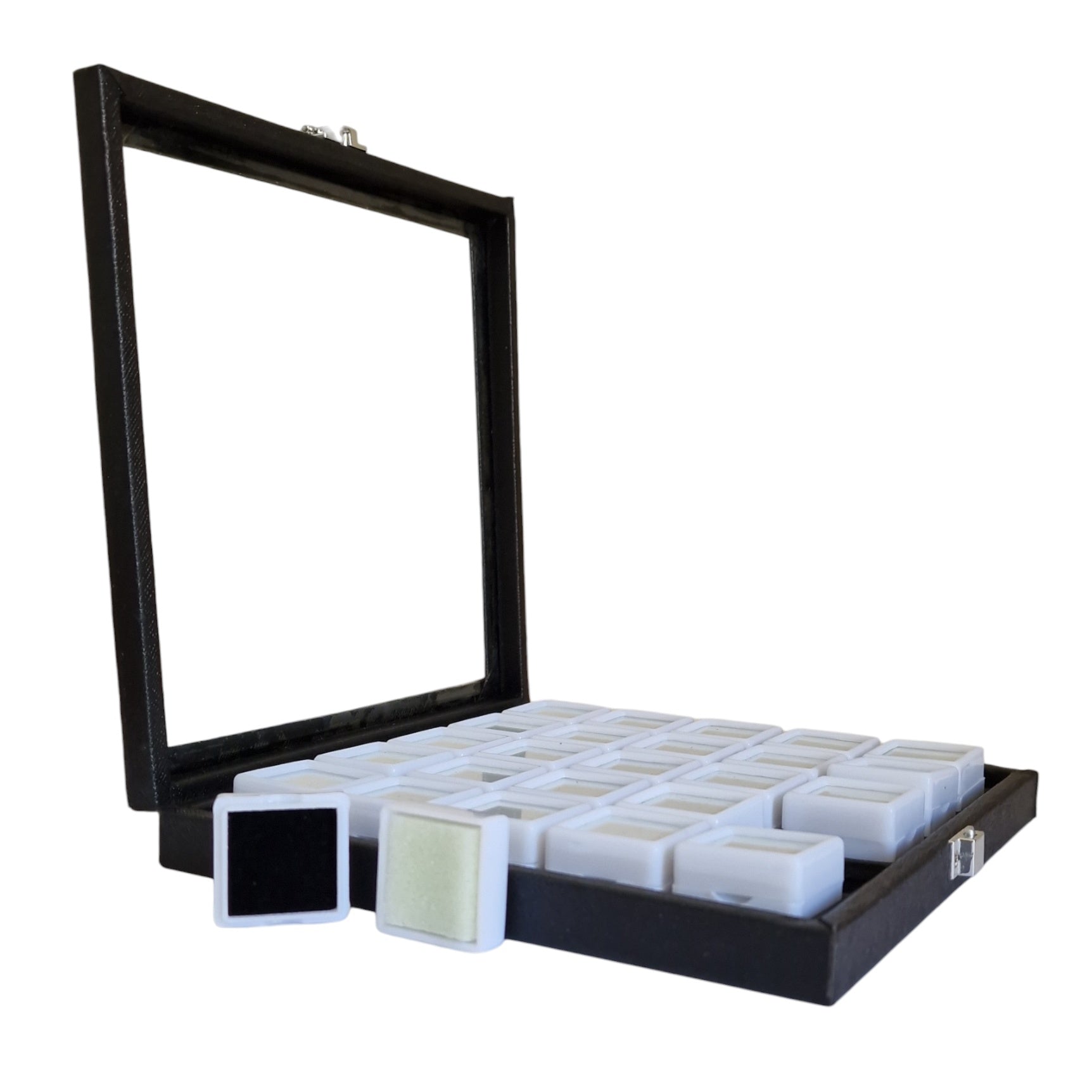 Black display case with glass front containing small white boxes on a white background