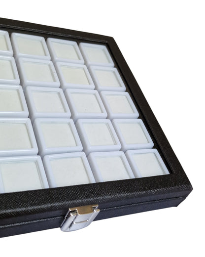 Black jewelry display case with multiple compartments on a white background