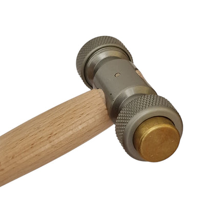 Close-up of a hammer with wooden handle and metallic head on a white background