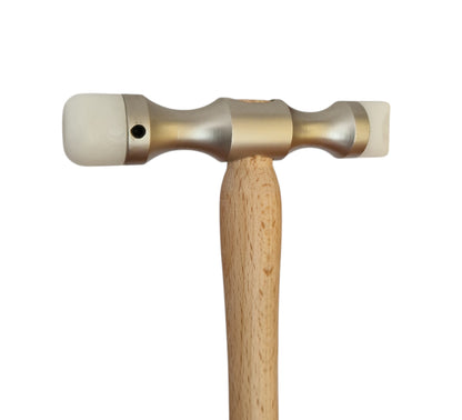 Double-ended planishing hammer with a smooth wooden handle and metal head, designed for interchangeable Delrin tips used in jewellery and metalworking.