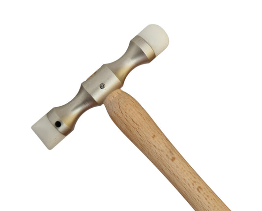 Double-ended planishing hammer with a smooth wooden handle and metal head, designed for interchangeable Delrin tips used in jewellery and metalworking.