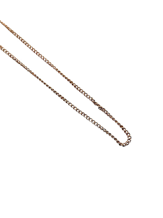 Gold chain necklace on a white background