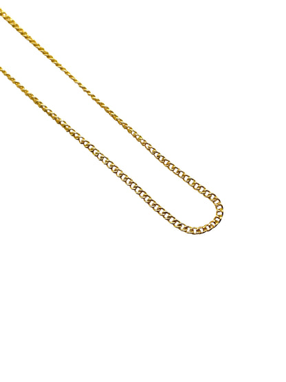 Gold chain necklace on a white background