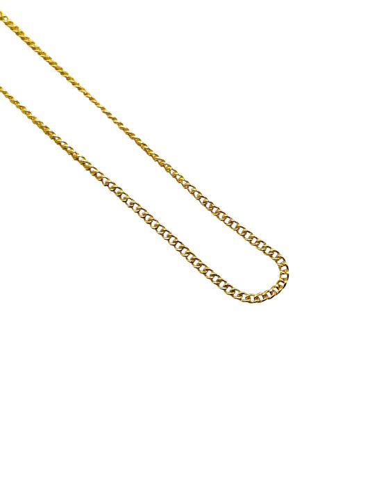 Gold chain necklace on a white background