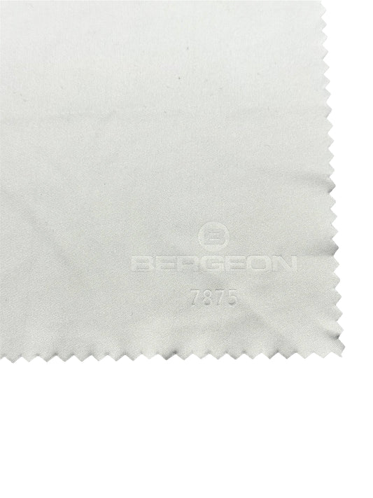Close-up of a white fabric with a brand logo on a white background