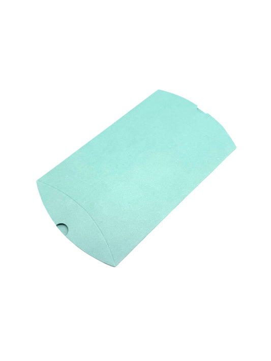 “Medium light green pillow gift box in curved design, flat-packed and eco-friendly – angled view”