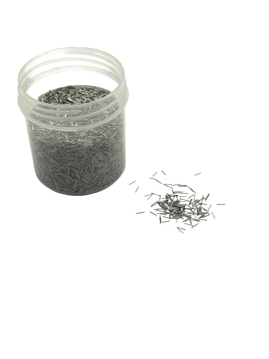 Clear container with small metal polishing pins on a white background