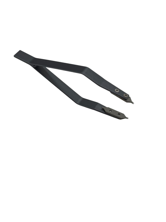 Black metal tongs on a white background