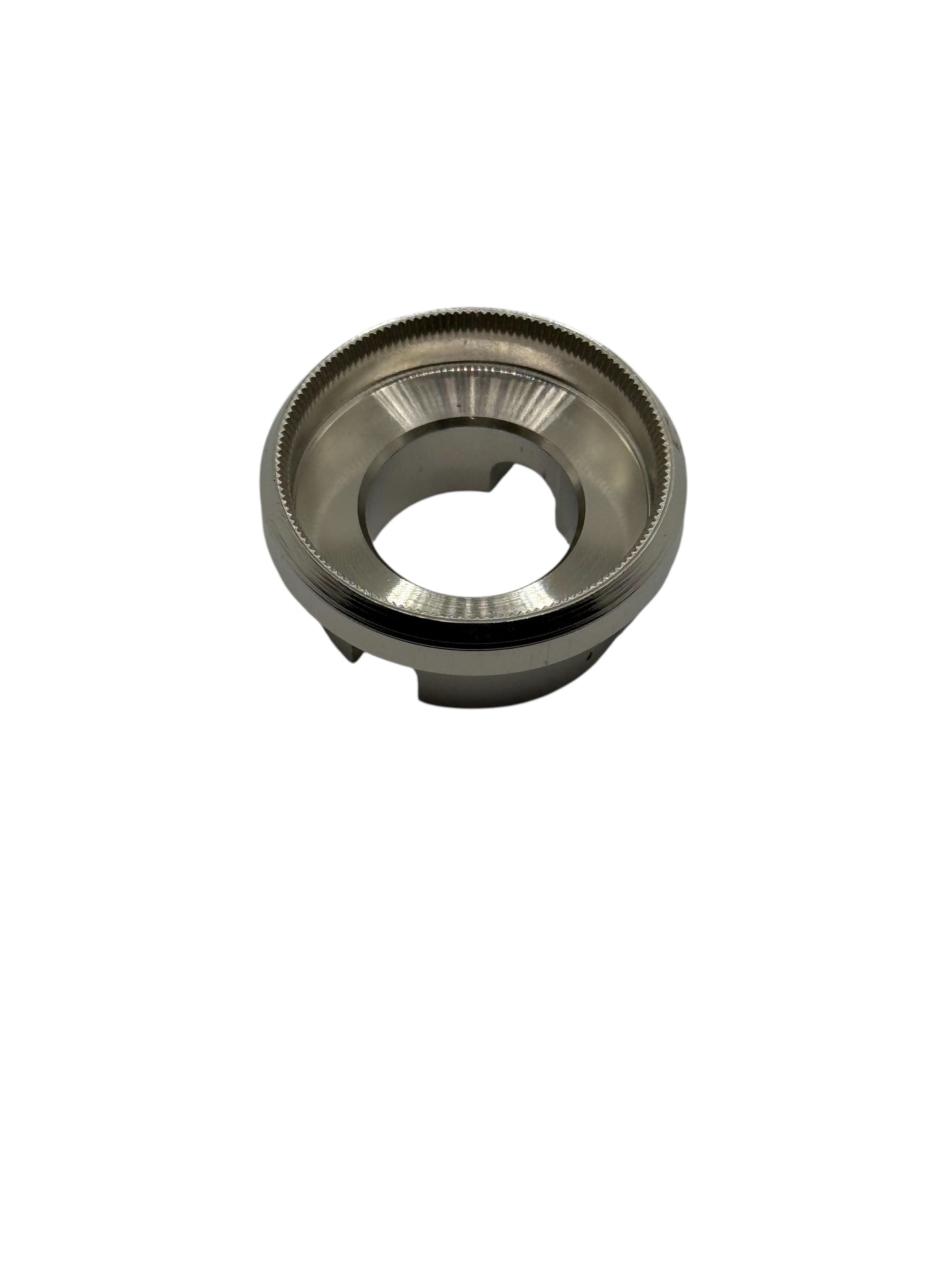 Metallic die with knurled edges on a white background