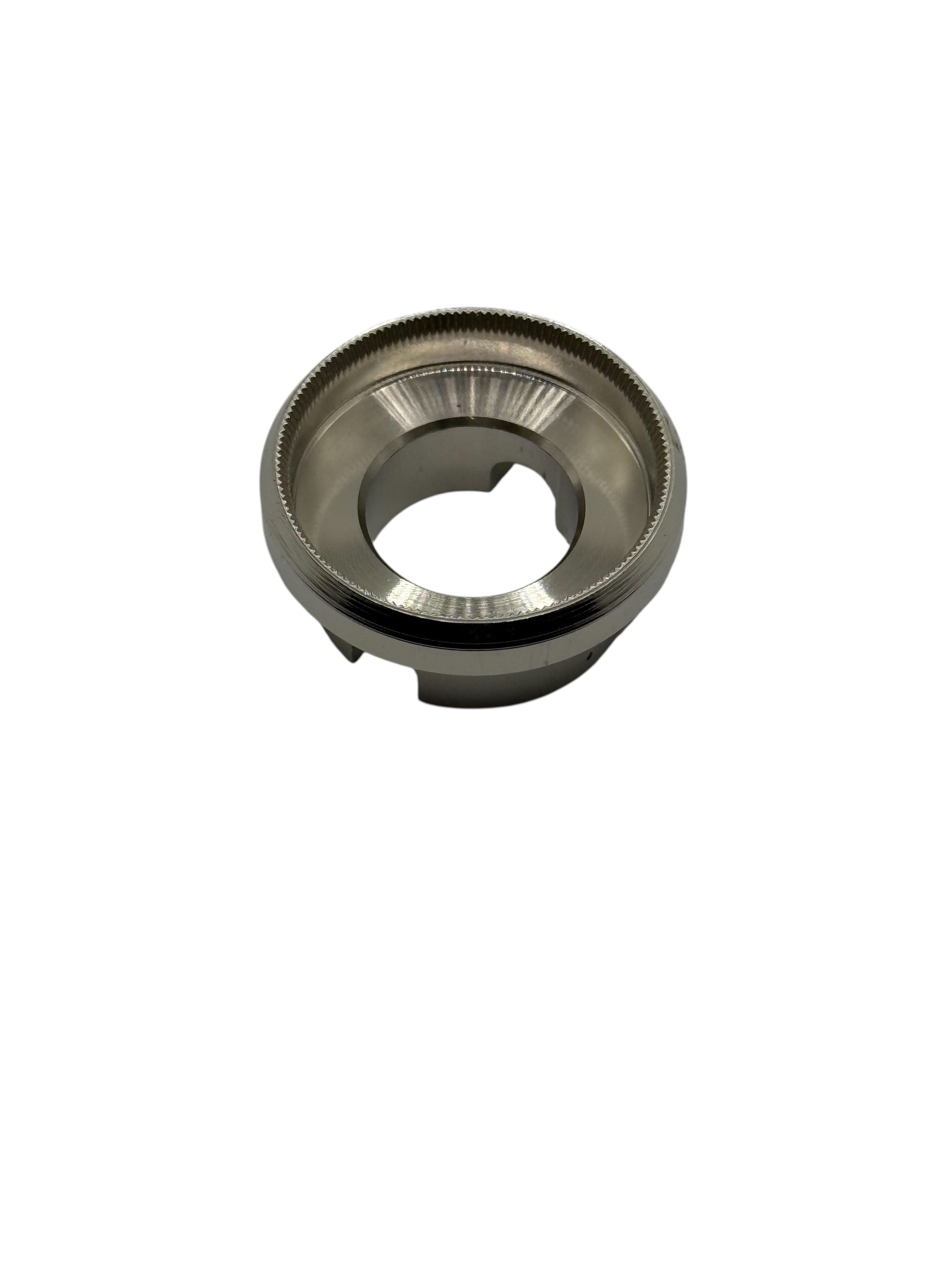 Metallic die with knurled edges on a white background