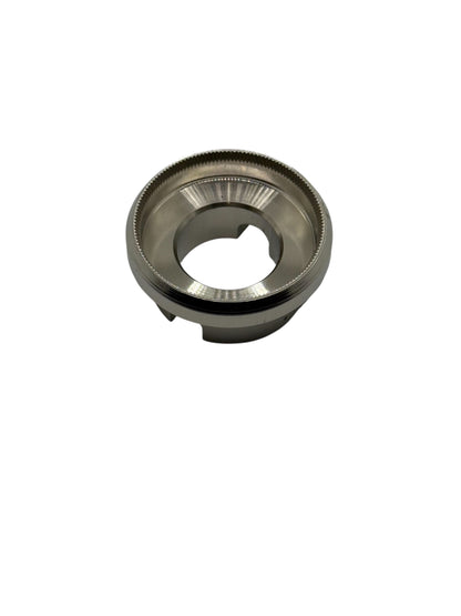Metallic die with knurled edges on a white background