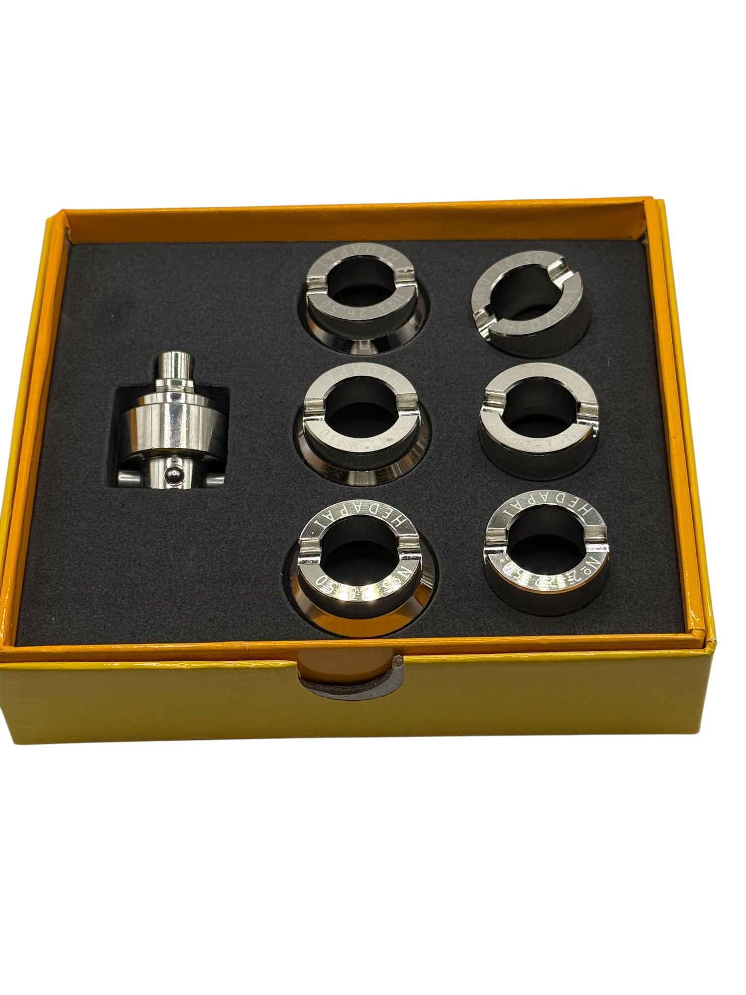 Set of metal components in a yellow box on a white background