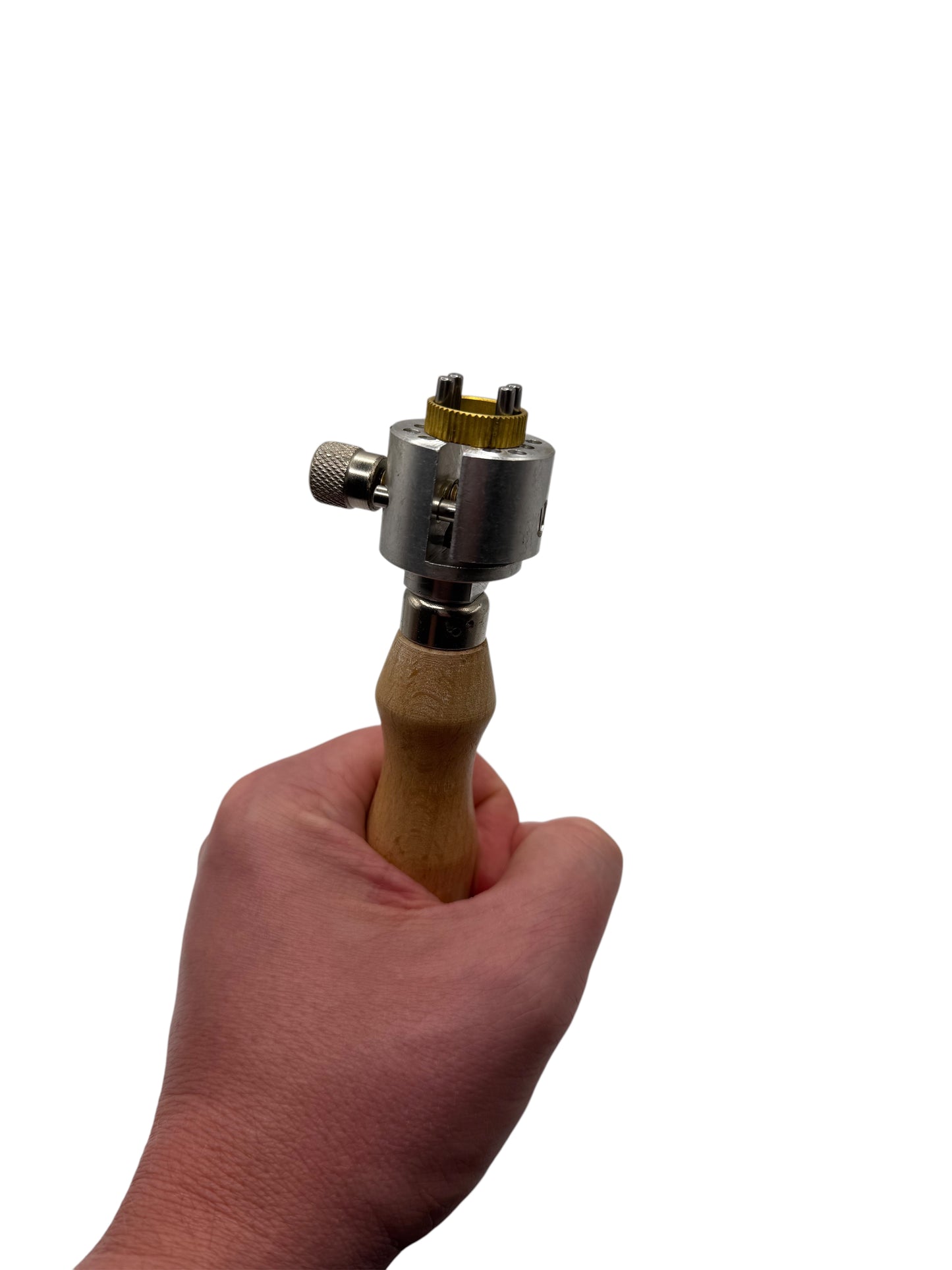 Hand holding a tool with a wooden handle and metal components on a white background