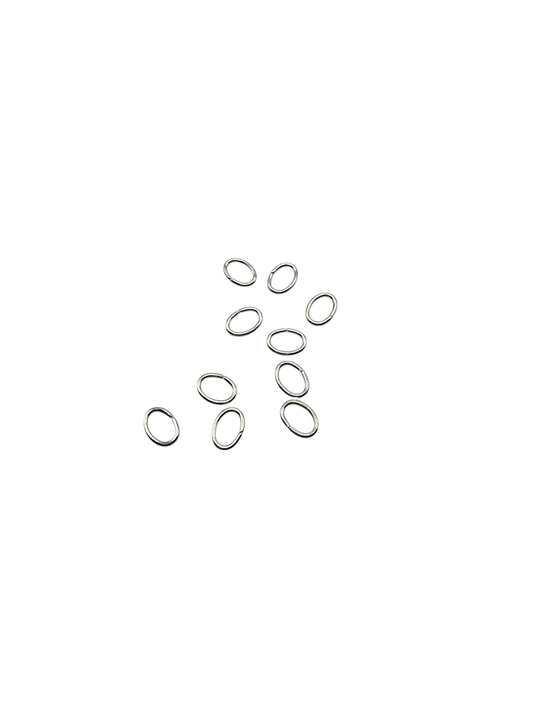 Silver oval jump rings on a white background