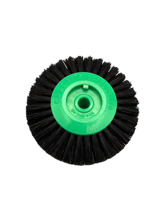 Circular black bristle brush with a green plastic centre