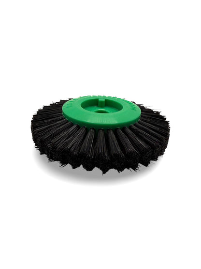 Circular black bristle brush with a green plastic centre