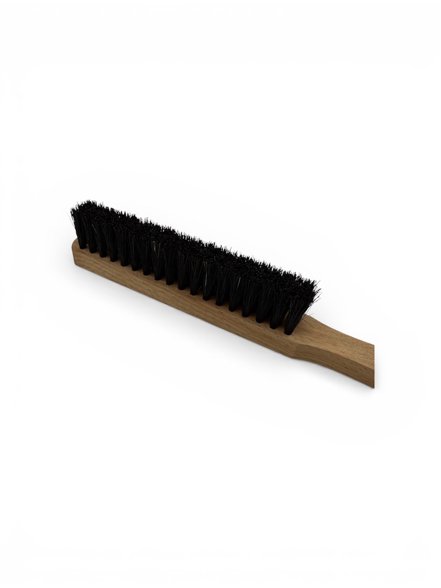 Close up of a black bristle brush for jewellery benches