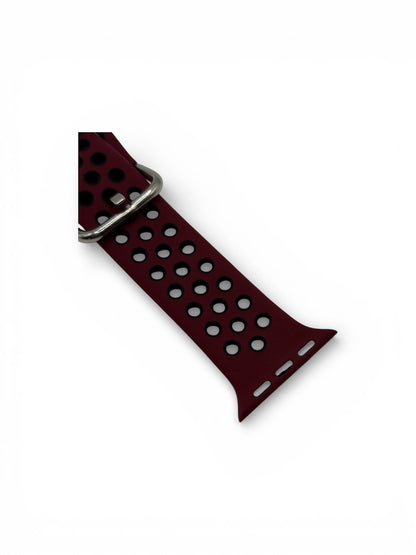 A dark red perforated silicone watch band with a silver metal buckle, shown on a plain white background.