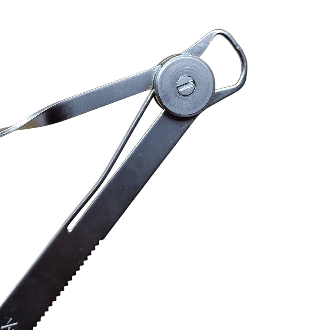 Close up of A polished steel degree gauge with millimeter readings and a spring-action mechanism.