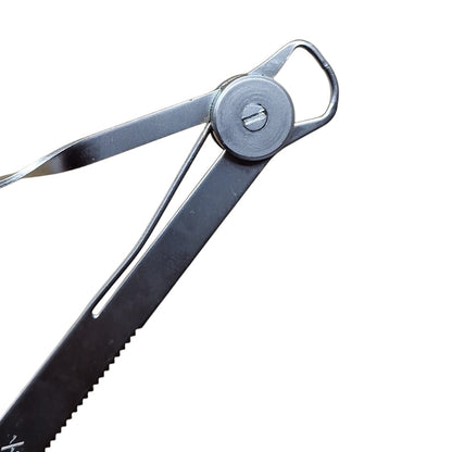 Close up of A polished steel degree gauge with millimeter readings and a spring-action mechanism.