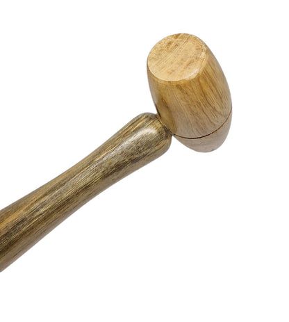 A wooden hammer with a cylindrical head and a handle, typically used for shaping metal or forming jewellery.