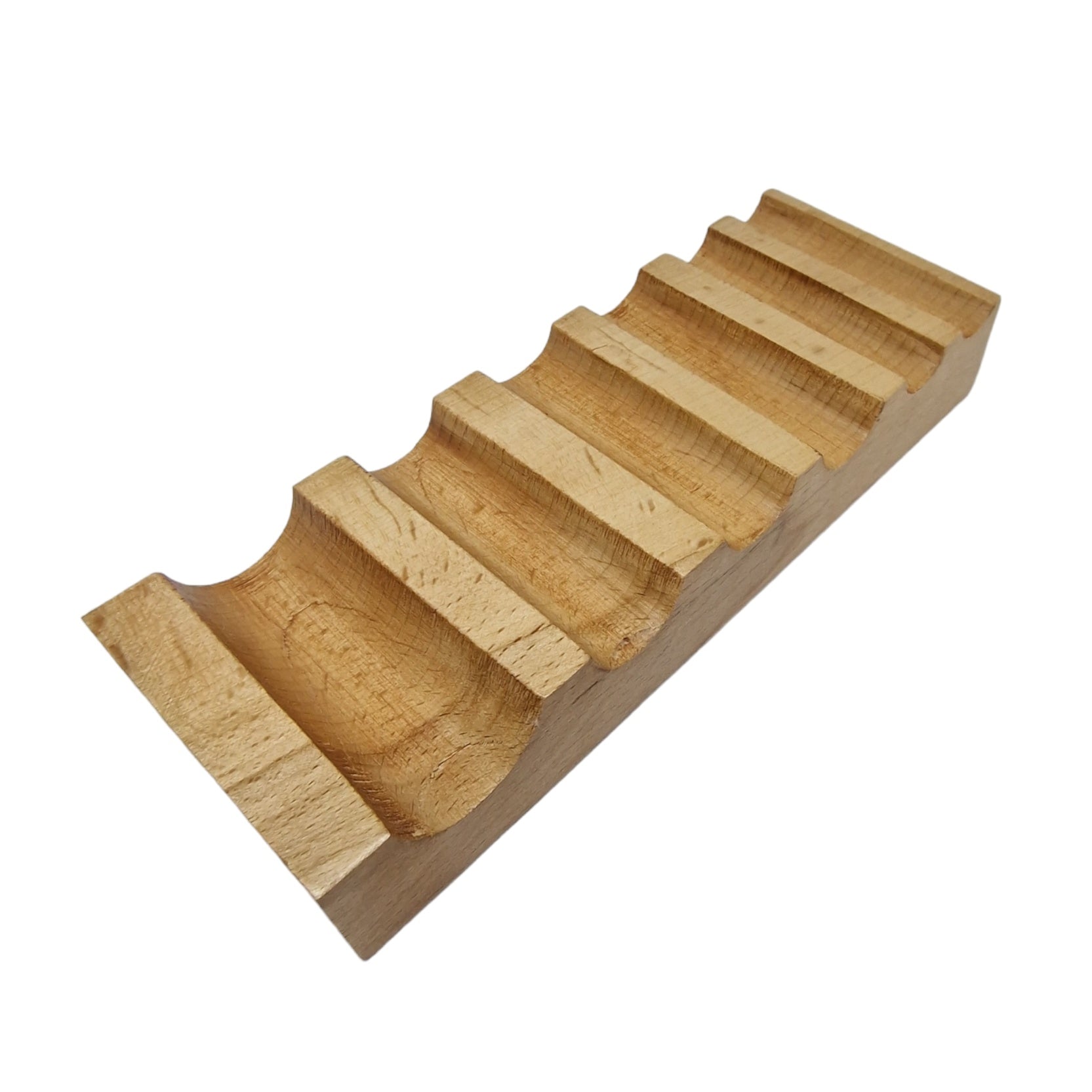 A well-polished, beige wooden swage block with semi-circular grooves used for metal bending.
