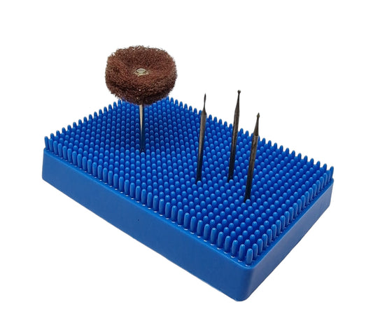 Blue plastic burr holder with rotary pieces being held