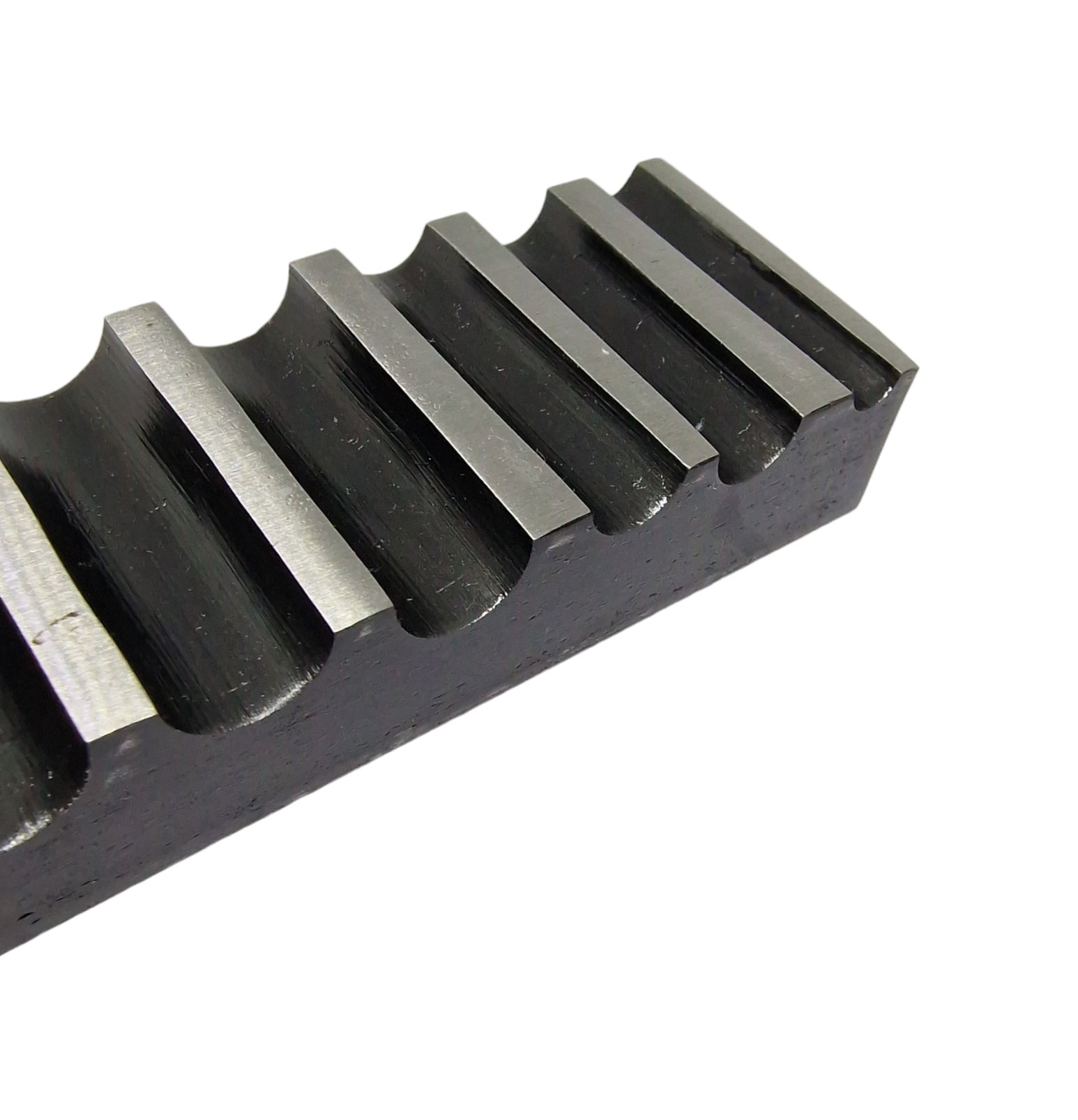 A close up of a  single-sided steel bending block with ten half-round grooves, used for forming, bending, and shaping metals.