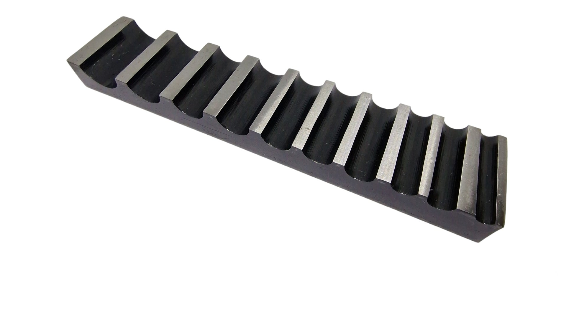 A single-sided steel bending block with ten half-round grooves, used for forming, bending, and shaping metals.