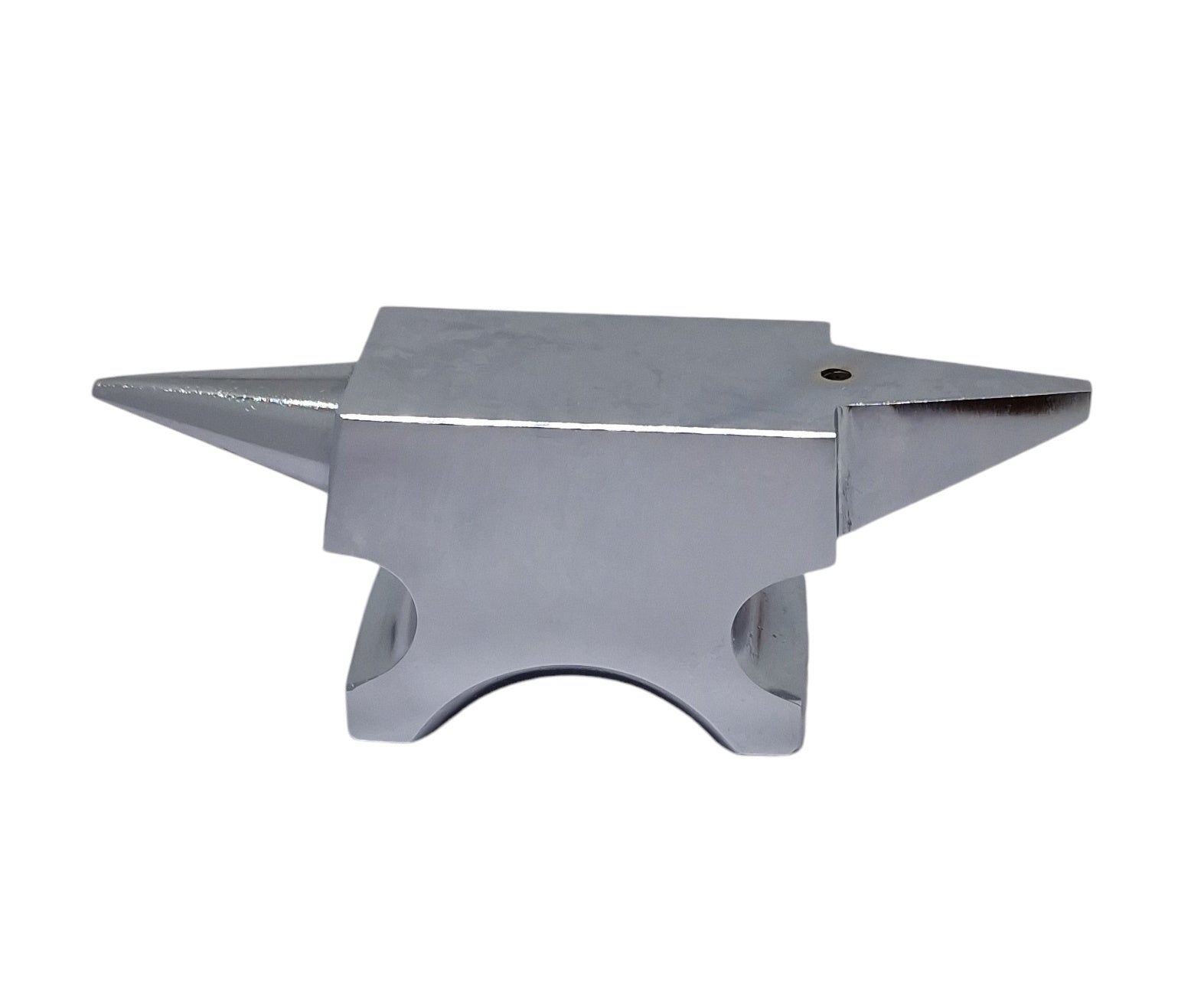 A polished silver anvil with one round horn and one flat base with a hole in the top face for riveting work.