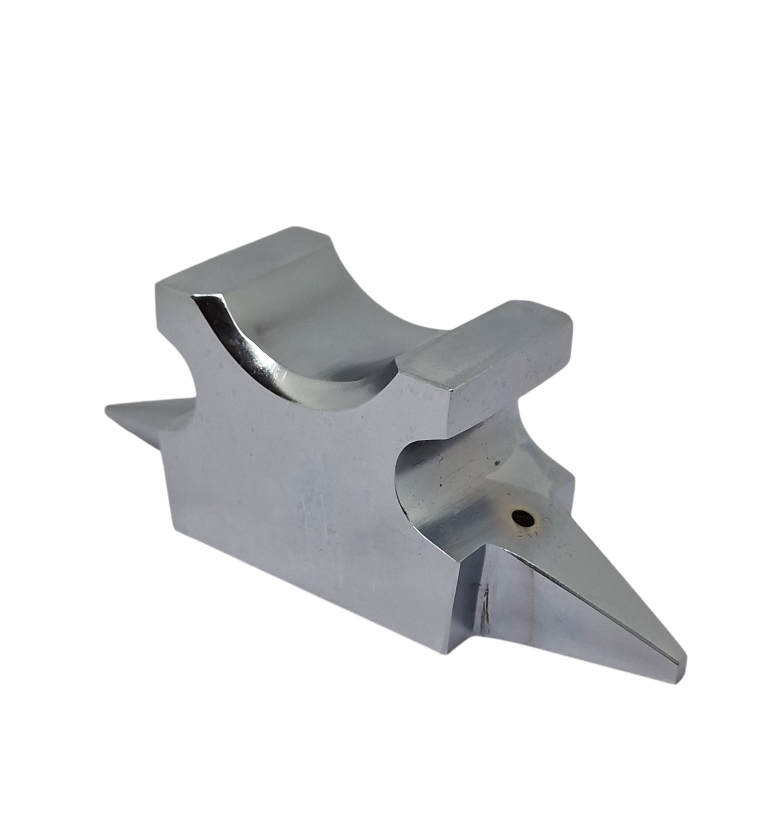 A polished silver anvil with one round horn and one flat base with a hole in the top face for riveting work.