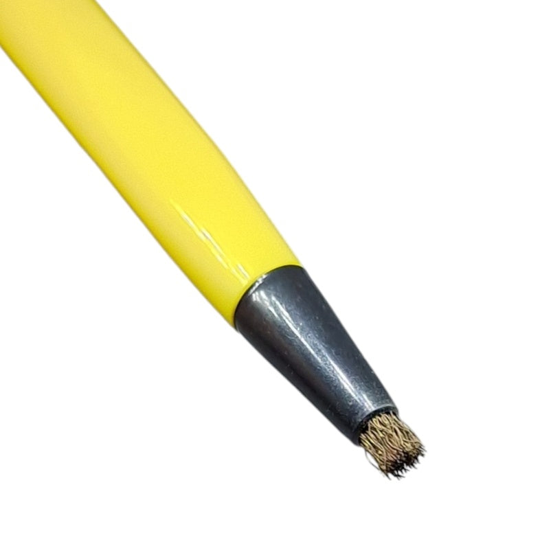 Close up of brass bristles coming out of a yellow plastic pen
