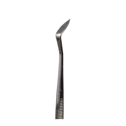 A double-ended stainless steel wax carving tool with one end pointed and the other shaped like a scoop.