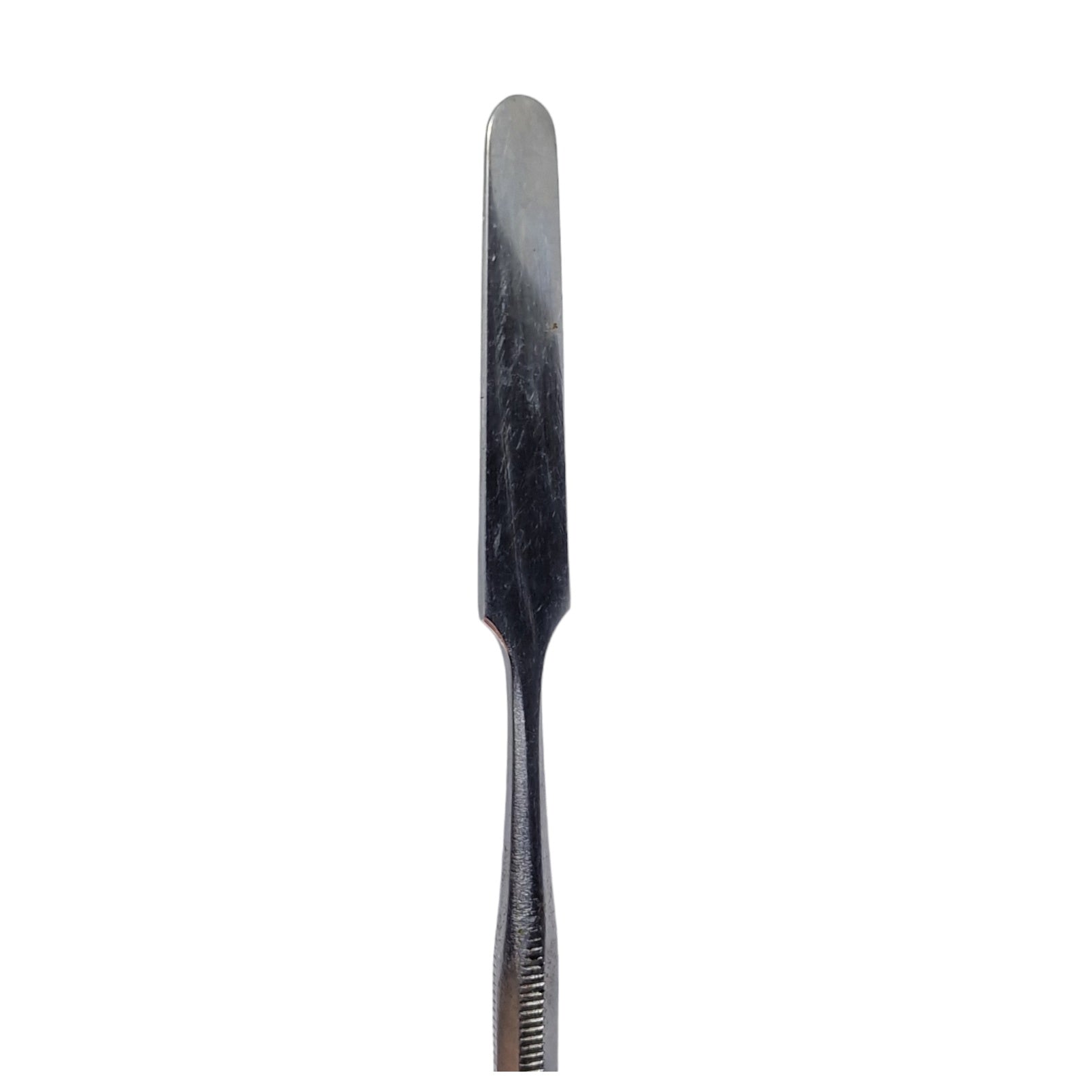 A single stainless steel wax carving tool with a straight blade and ribbed handle.