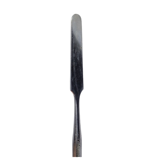 A single stainless steel wax carving tool with a straight blade and ribbed handle.