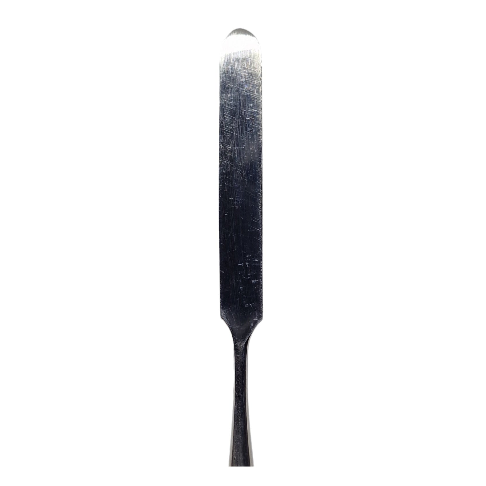 A stainless steel wax carving tool with a serrated edge and a smooth handle.