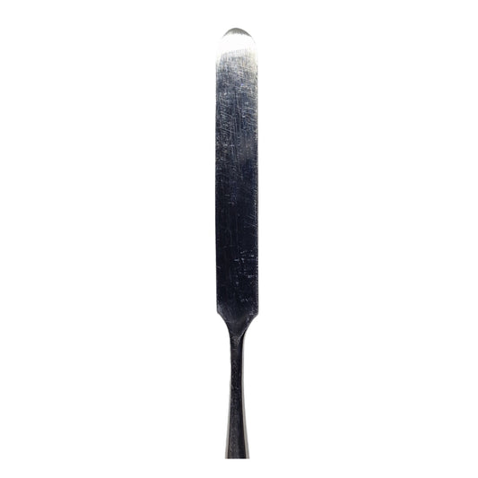 A stainless steel wax carving tool with a serrated edge and a smooth handle.