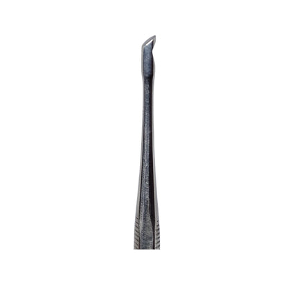 A double-ended stainless steel wax carving tool with one pointed end and one flat end, with visible grooves and usage marks.