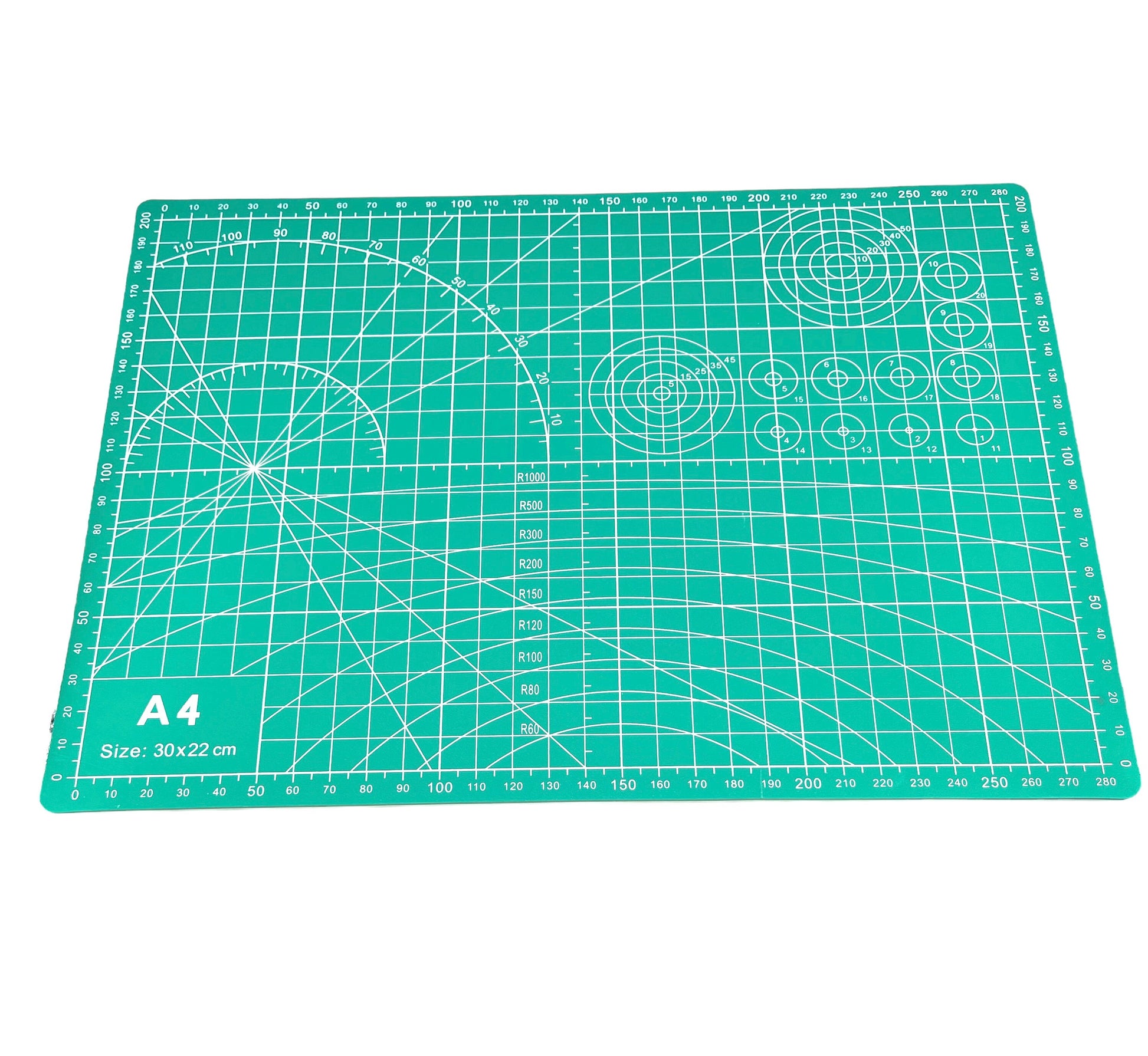 A green A4 cutting mat with grid lines and measurements marked for precision cutting.
