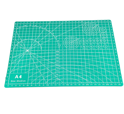 A green A4 cutting mat with grid lines and measurements marked for precision cutting.
